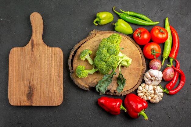 Top view fresh green broccoli with fresh vegetables on dark table salad ripe health