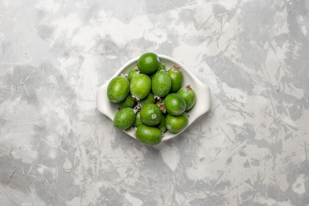 Top view fresh green feijoa inside plate on white surface fruit tree plant freshness mellow exotic color