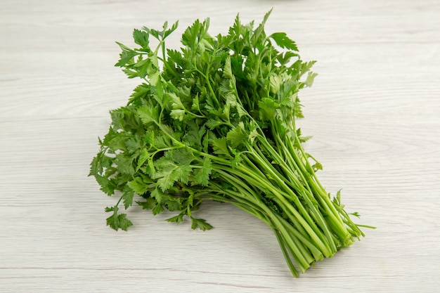 Top view fresh greens on white background