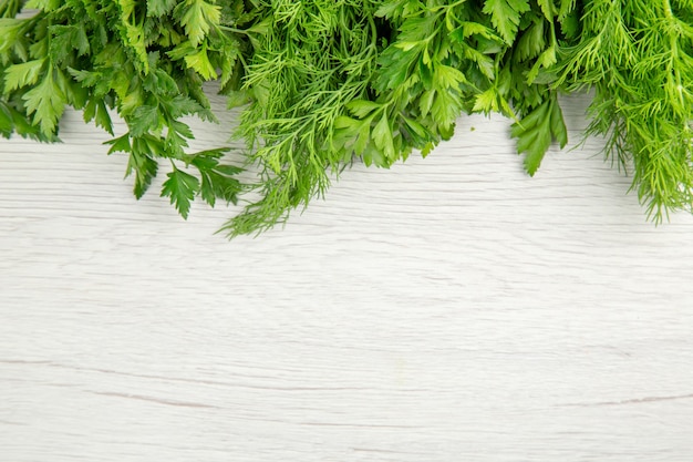 Top view fresh greens on white background