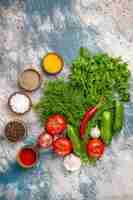 Free photo top view fresh greens with vegetables and seasonings on light background