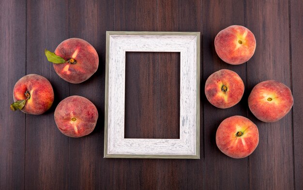 Top view of fresh and juicy peaches isolated on wood with copy space