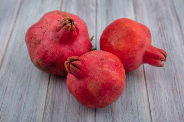 Top view of fresh juicy red pomegranates isolated on a grey background