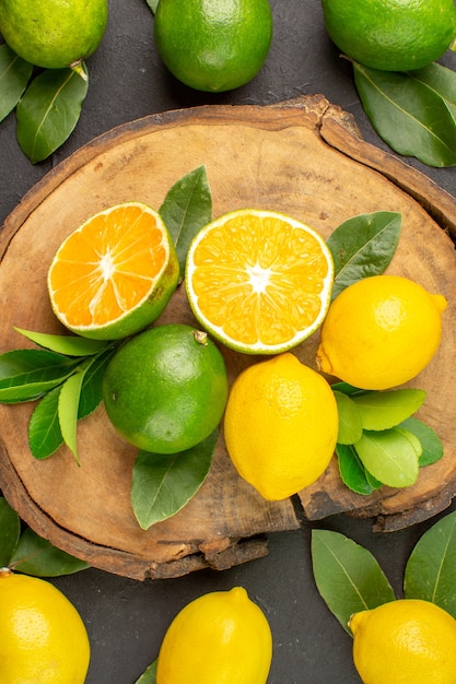 Top view fresh lemons on a dark table lime sour fruit citrus