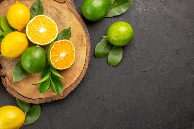 Top view fresh lemons on the dark table lime sour fruit citrus