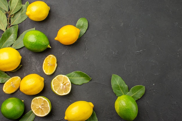 Top view fresh lemons sour fruits on a dark table citrus lime fruit