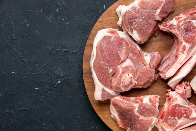 Top view fresh meat slices raw meat on round wooden desk on dark food freshness animal cow food kitchen