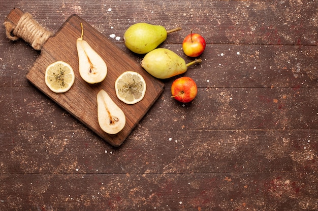 Top view fresh mellow pears on brown desk