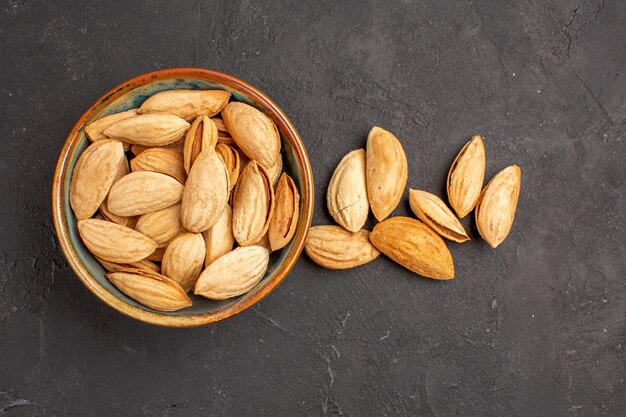 Top view of fresh nuts on a dark surface