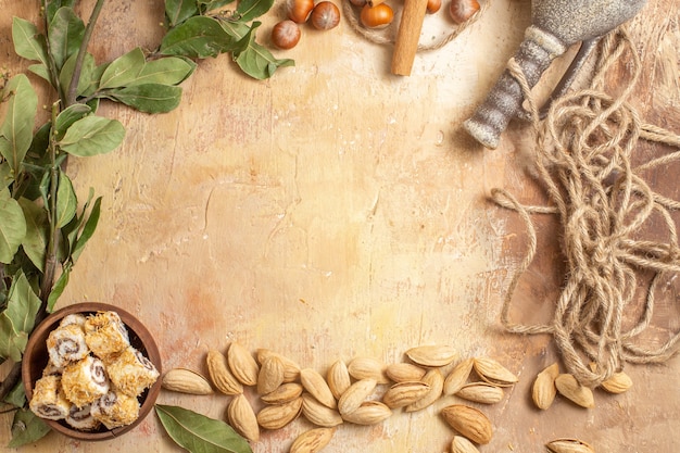 Top view of fresh nuts with candies on wooden surface