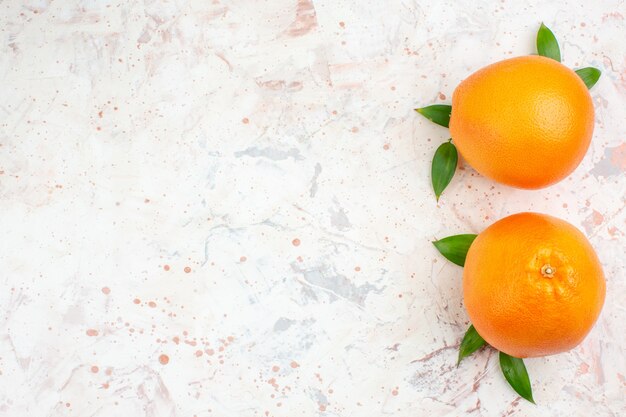 Top view fresh oranges on bright isolated surface with free space