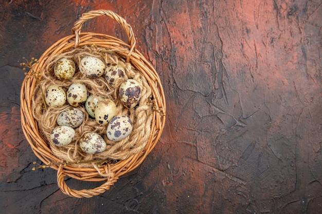 Free photo top view of fresh organic poultry farm eggs in a tissue basket on the right side on a brown background