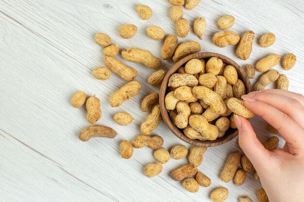 Top view fresh peanuts on white desk