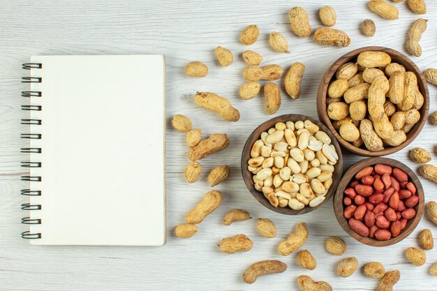 Top view fresh peanuts on white table