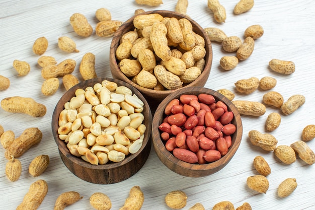 Top view fresh peanuts on white table