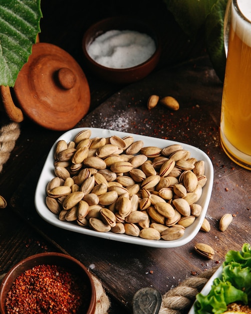 A top view fresh peanuts with green salad on the wooden desk snack nut photo