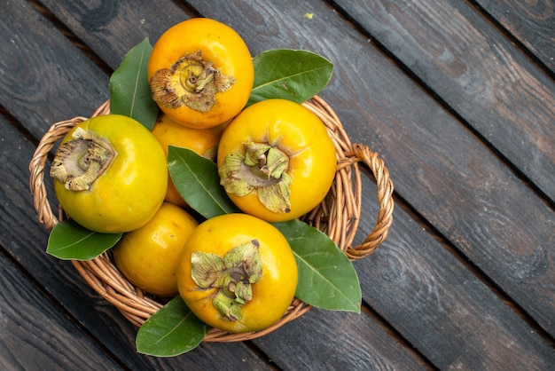 Top view fresh persimmons ripe sweet fruits on a wooden rustic table, fruit mellow 