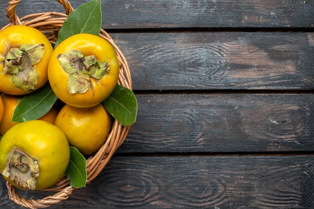 Top view fresh persimmons ripe sweet fruits on the wooden rustic table, fruit mellow 