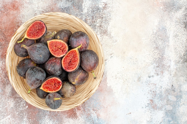 Free Photo top view fresh persimmons in wicker basket on nude background