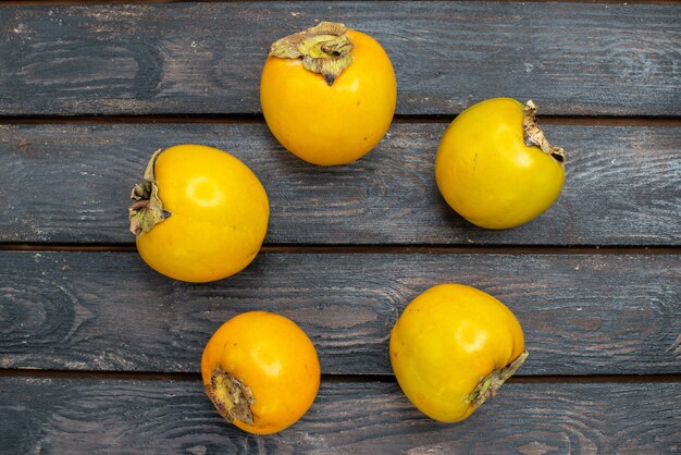 Top view fresh persimmons on the wooden rustic table, fruit mellow ripe