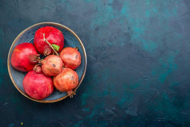 Top view fresh pomegranates on dark-blue