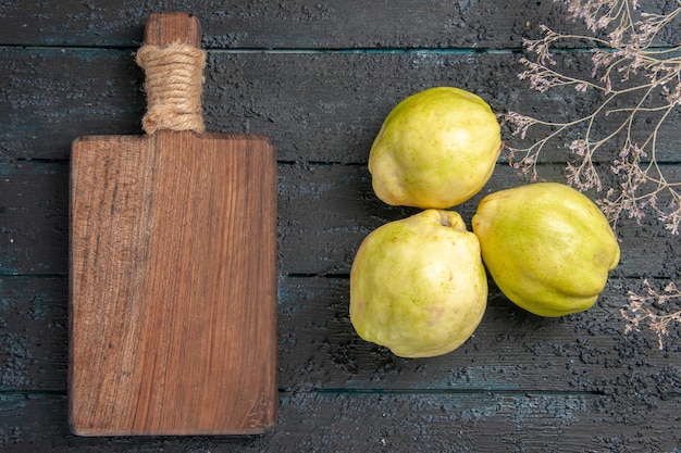 Free photo top view fresh quinces mellow and sour fruits on dark blue desk plant fresh sour fruit tree ripe