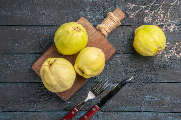 Top view fresh quinces mellow and sour fruits on dark-blue desk plant fresh sour fruits tree ripe