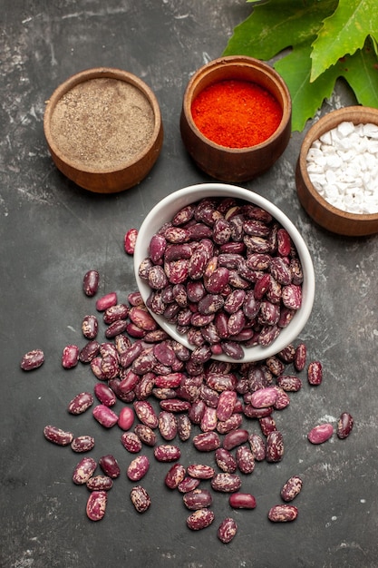 Top view fresh raw beans with seasonings on grey surface