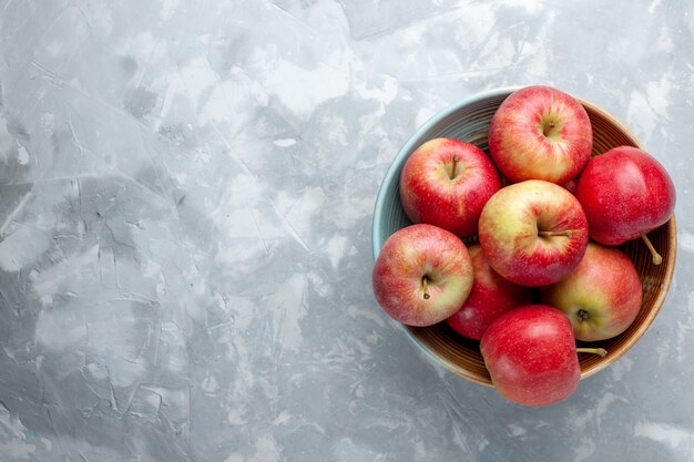 Top view fresh red apples inside plate on white background fruit fresh mellow ripe vitamine