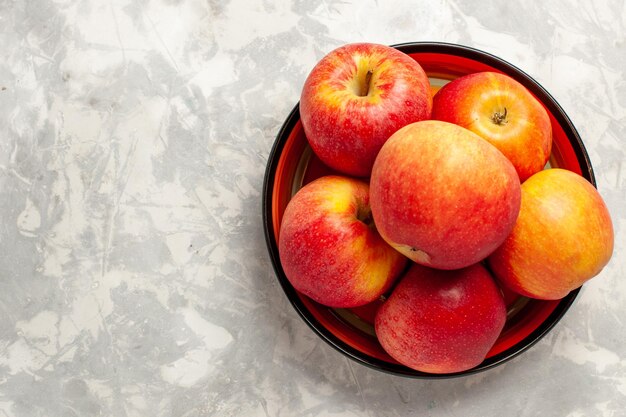 Top view fresh red apples mellow fruits on the white surface