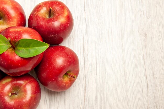 Top view fresh red apples mellow and ripe fruits on white desk fruits color fresh many plant tree