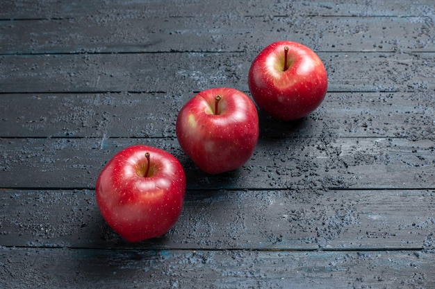 Top view fresh red apples ripe and mellow fruits on dark-blue desk many fruit red fresh plant color tree