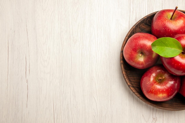 Top view fresh red apples ripe and mellow fruits on white floor fruit red color tree fresh plant