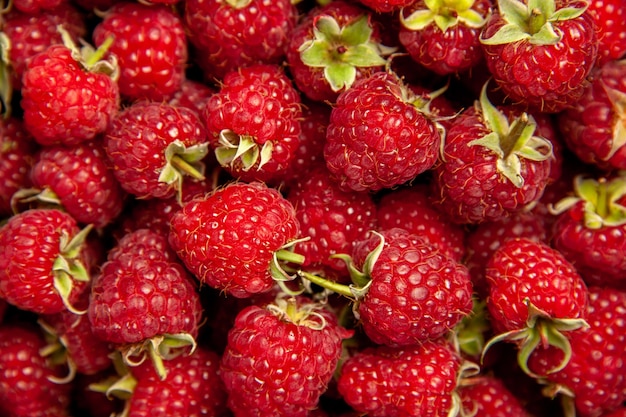 Top view fresh red raspberries on grey background