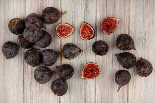 Top view of fresh ripe black mission figs isolated on a grey wooden wall