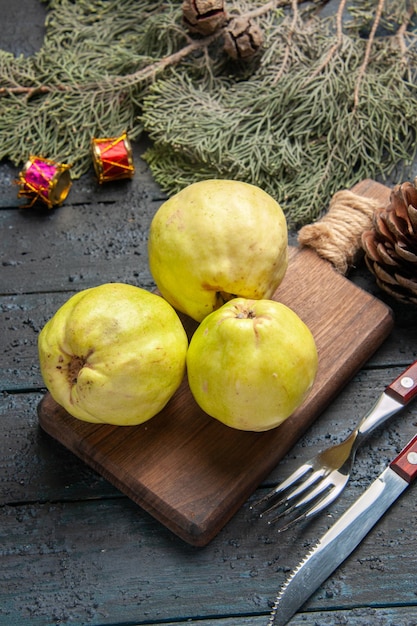 Top view fresh ripe quinces sour fruits on dark blue rustic desk fresh plant ripe fruit many tree