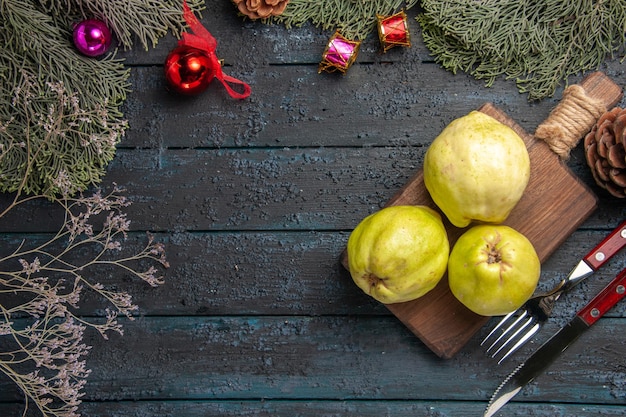 Top view fresh ripe quinces sour fruits on dark-blue rustic desk many fresh plant ripe fruit tree