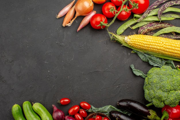 Top view fresh ripe vegetables composition on grey background