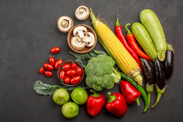 Top view fresh ripe vegetables composition on grey background