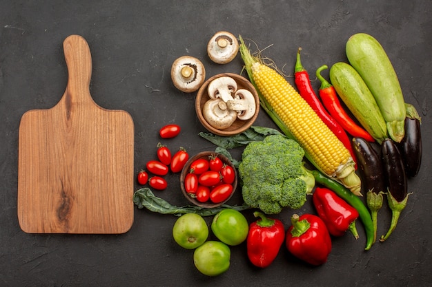 Top view fresh ripe vegetables composition on grey desk