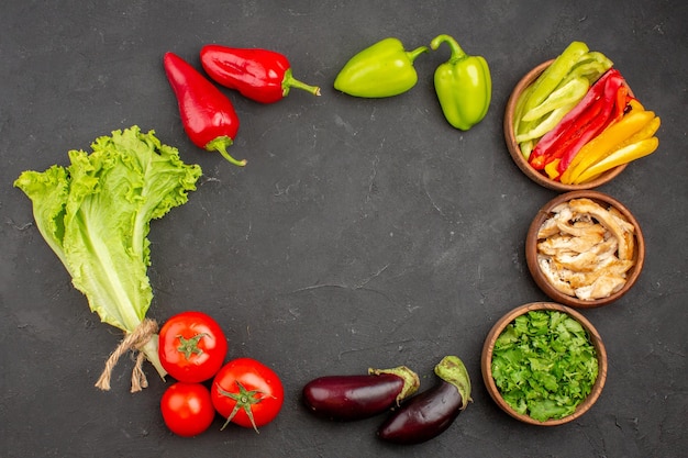 Top view of fresh ripe vegetables with greens on black