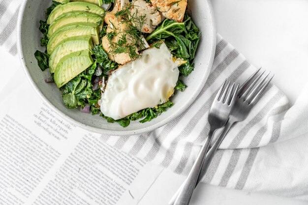 Top view of the fresh salad with a fried egg