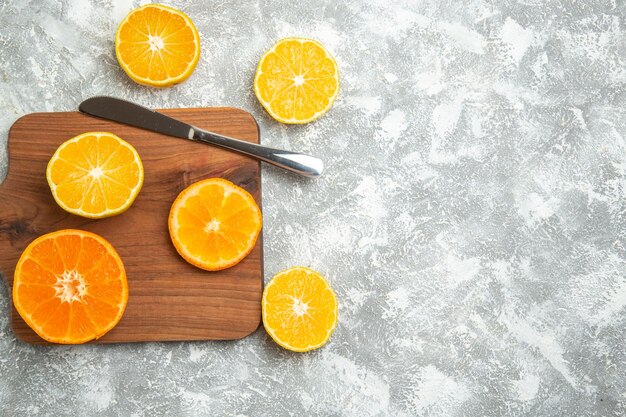 Top view fresh sliced oranges mellow citruses on white desk ripe fruit exotic fresh tropical