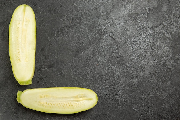 Top view of fresh sliced squashes on grey surface