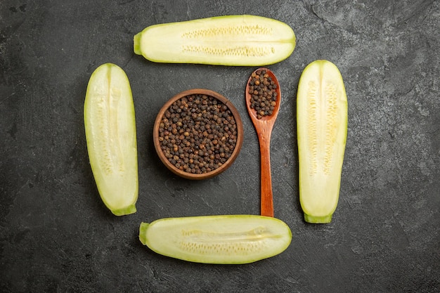 Top view of fresh sliced squashes on grey surface