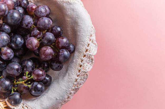 Free photo top view of fresh sour grapes inside basket on pink surface