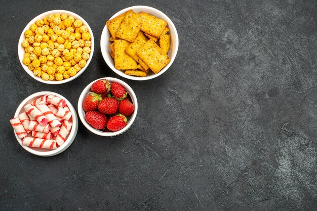 Top view fresh strawberries with different snacks