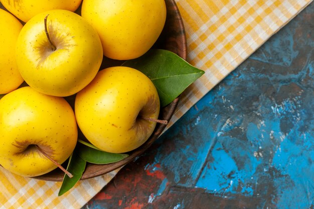 Top view fresh sweet apples inside plate on blue background