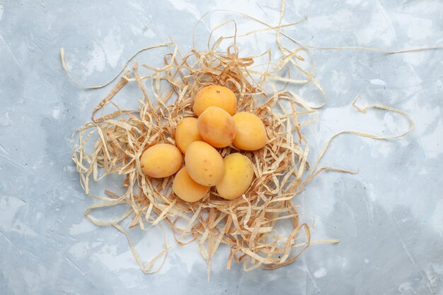 Top view of fresh sweet apricots mellow fruits on white-light desk, fruit fresh food meal vitamine