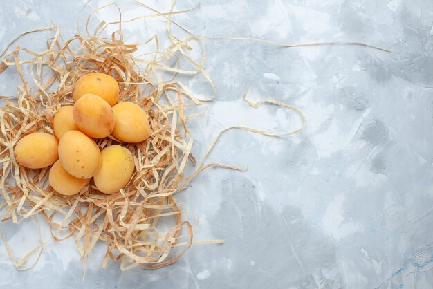 Top view of fresh sweet apricots mellow fruits on white-light, fruit fresh food meal vitamine